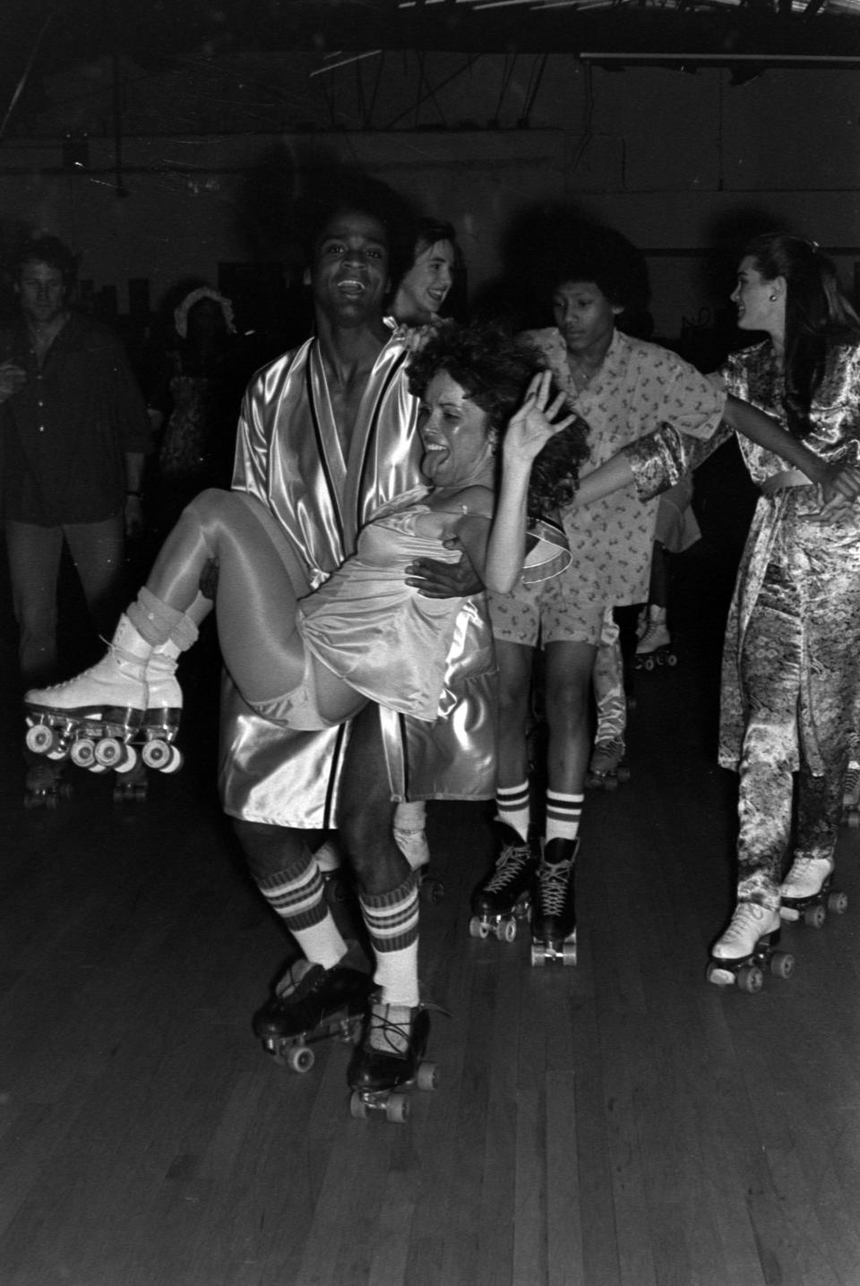 The scene at the Roxy in New York, 1980, with actress Brooke Shields in the background. Rodgers was a regular at the roller skating rink. - Credit: WWD