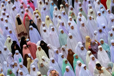 Muslims attend an Eid al-Fitr mass prayer to mark the end of the holy fasting month of Ramadan at a mosque in the southern province of Pattani, Thailand, June 25, 2017. REUTERS/Surapan Boonthanom
