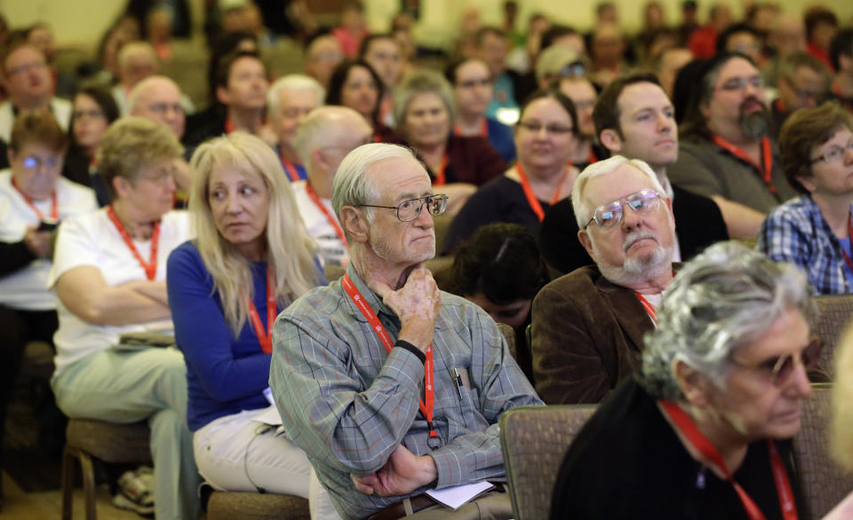 People look on as David Silverman, president of the American Atheists, addresses the American Atheists National Convention in Salt Lake City on Friday, April 18, 2014. In an effort to raise awareness and attract new members, the organization is holding their national conference over Easter weekend in the home of The Church of Jesus Christ of Latter-day Saints. (AP Photo/Rick Bowmer)