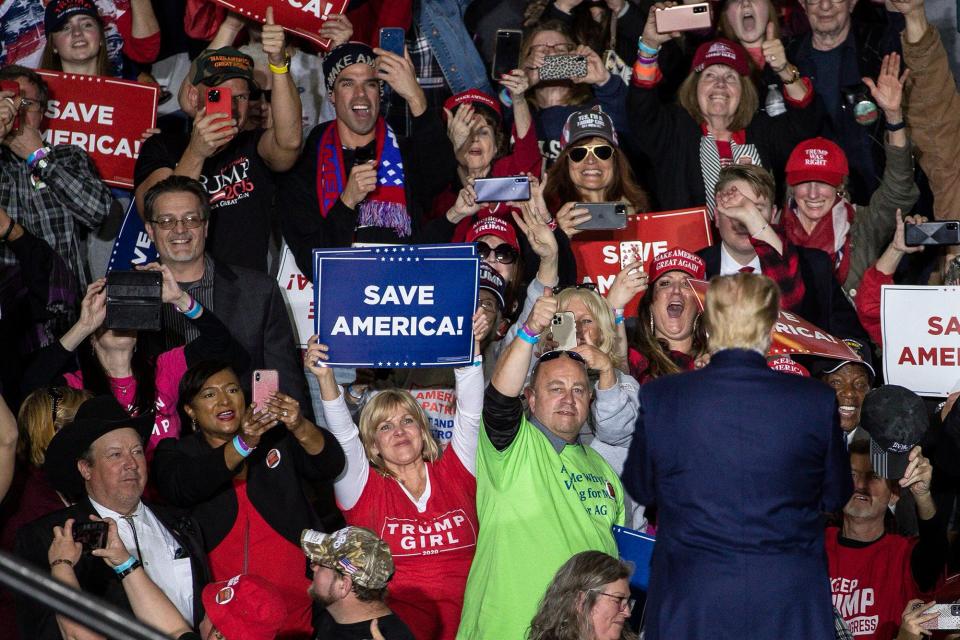 Former President Donald Trump waves at supporters before speaking during a Save America rally at the Michigan Stars Sports Center in Washington Township on April 2, 2022.