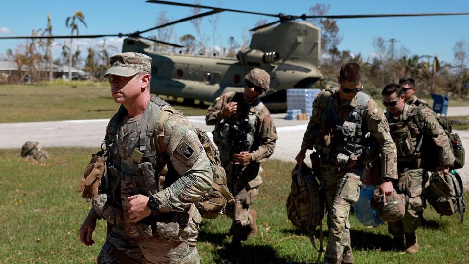 Members of Florida Army National Guard arrive on October 2, 2022, in Pine Island, Florida. Residents are being encouraged to leave because the only road onto the island is impassable and electricity and water remain knocked out after Hurricane Ian passed through the area.