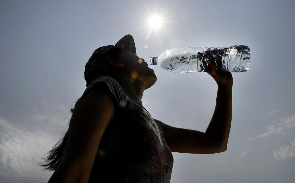 People who drink water from plastic bottles are particularly at risk, the study found (Photo by Fred TANNEAU / AFP) 