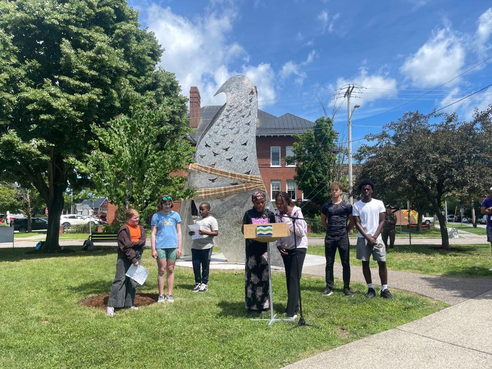 Students from the Integrated Arts Academy and peer leaders from the Burlington School District's Summer Racial Justice Academy read poems at the unveiling of "Embrace and Belonging," a new sculpture in Dewey Park representing equity and inclusion, on June 26, 2024.