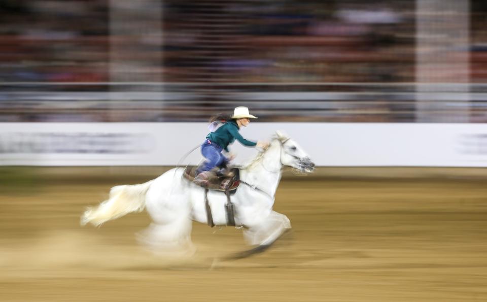 Ashley Castleberry of Montgomery, Texas, competes Friday in barrel racing at the St. Paul Rodeo.