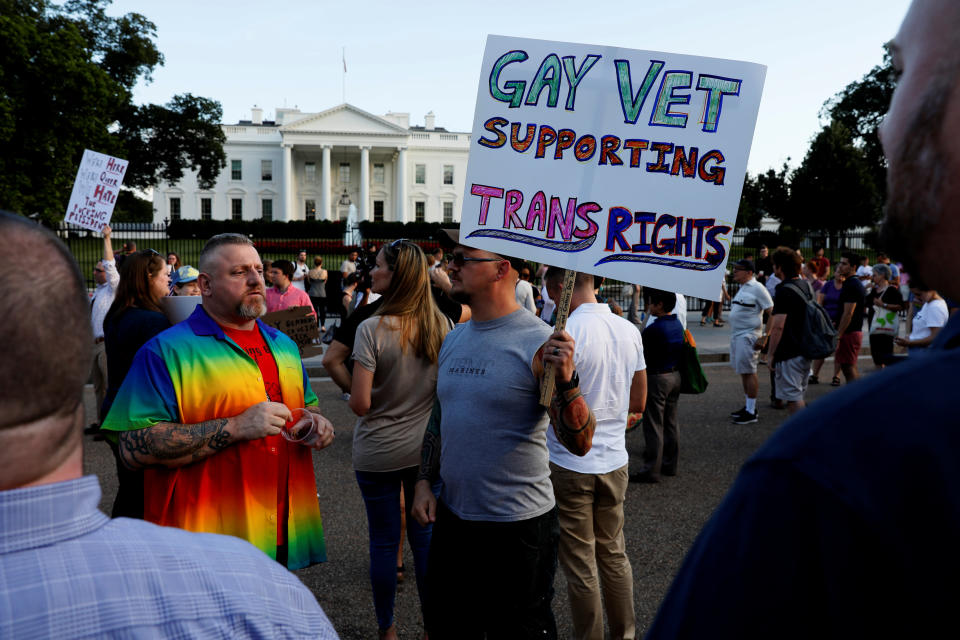 Demonstrators gather to protest U.S. President Donald Trump's announcement that he plans to reinstate a ban on transgender individuals from serving in any capacity in the U.S. military, at the White House in Washington, U.S. July 26, 2017. REUTERS/Jonathan Ernst