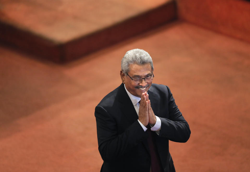 FILE- Sri Lankan President Gotabaya Rajapaksa greets ruling party lawmakers as he departs along the well of the parliament after delivering his policy speech in Colombo, Sri Lanka, Aug. 20, 2020. Rajapaksa softened his majoritarian stand and struck a conciliatory tone toward the ethnic minorities on Tuesday, promising post-civil war reforms for equal rights and urging politicians to refrain from fanning ethnic tensions. (AP Photo/Eranga Jayawardena, File)