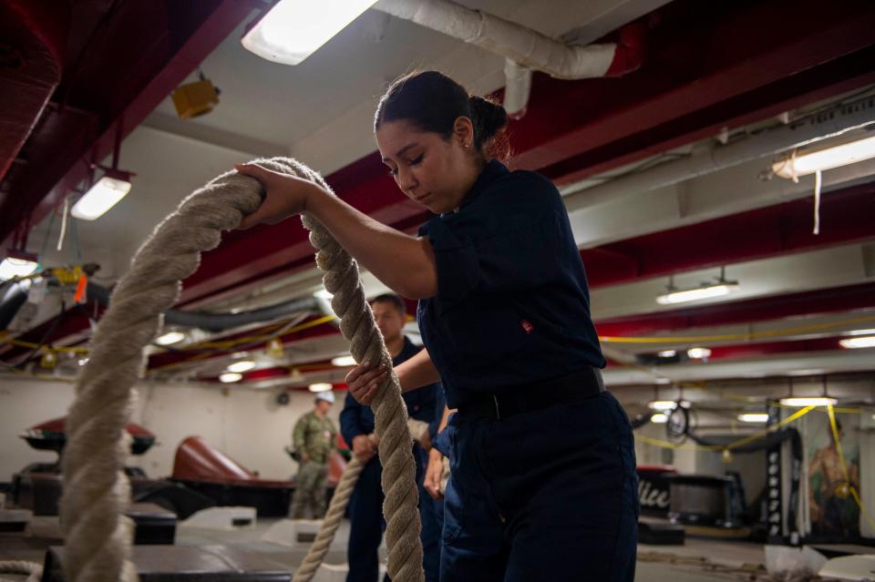 U.S. Navy Boatswain’s Mate Seaman Cassandra Hortz prepares mooring lines in the forecastle aboard the USS Theodore Roosevelt as it exits dry dock on Aug. 4.