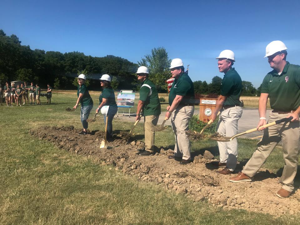 Benton-Carroll-Salem School District board members and Superintendent Guy Parmigian shovel ceremonial mounds of dirt Tuesday at a groundbreaking ceremony for the new Oak Harbor Intermediate School. The new school is scheduled to be completed by November 2023.
