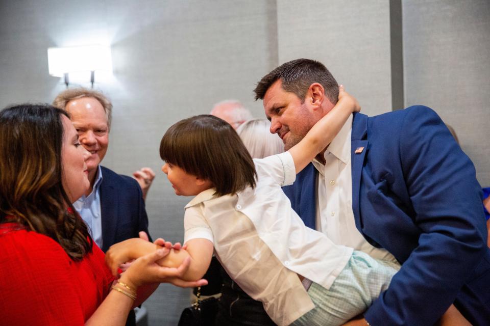 Lauren Massey grabs her son Wells Massey as he tells her "daddy won," while his father AJ Massey, the Republican candidate for Madison County Mayor, holds him after early results put Massey in the lead during a watch party at DoubleTree by Hilton Hotel Jackson on Thursday, August 4, 2022, in Jackson, TN. Up for election this year are candidates in the Madison County general election as well as statewide primary elections. 