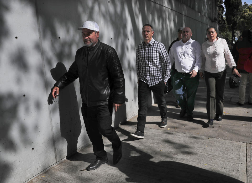 Adrian LeBaron, left, who lost relatives and friends in a Nov. 4, 2019 ambush in northern Mexico, leaves the office of the Special Prosecutor for Organized Crime Investigation, where they met with authorities in Mexico City, Tuesday, Jan. 7, 2020. Prosecutors said Tuesday more than 40 suspects have been identified in connection with the slaughter of the nine U.S. dual-national women and children. (AP Photo/Marco Ugarte)