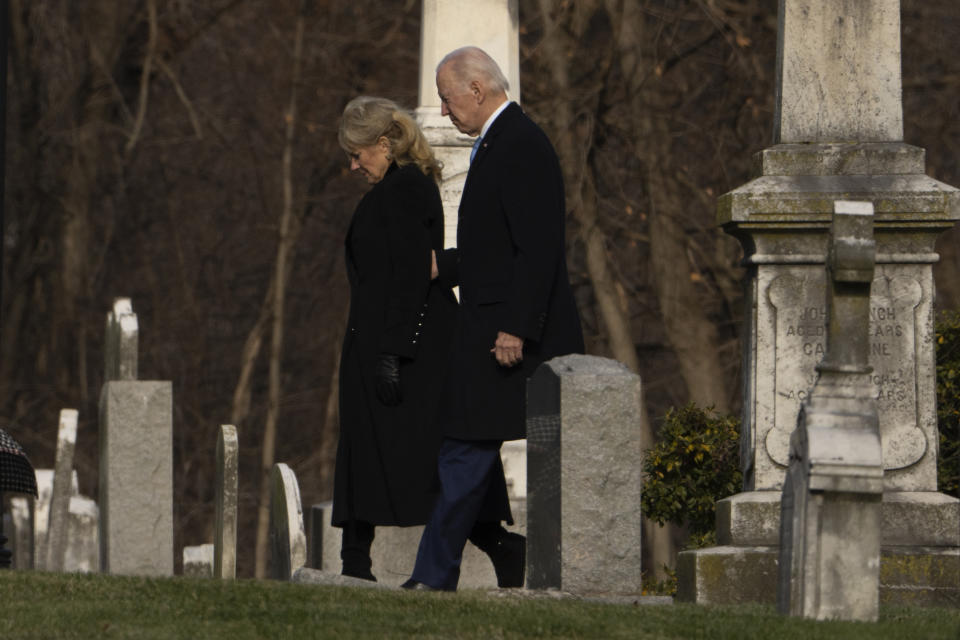 President Joe Biden and first lady Jill Biden walk between tombstones to attend Mass at St. Joseph on the Brandywine Catholic Church in Wilmington, Del., on Sunday, Dec. 18, 2022. Sunday marks the 50th anniversary of the car crash that killed Biden's first wife Neilia Hunter Biden and 13-month-old daughter Naomi. (AP Photo/Manuel Balce Ceneta)