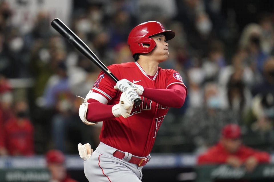 Los Angeles Angels' Shohei Ohtani watches the path of his solo home run against the Seattle Mariners in the first inning of a baseball game Sunday, Oct. 3, 2021, in Seattle. (AP Photo/Elaine Thompson)