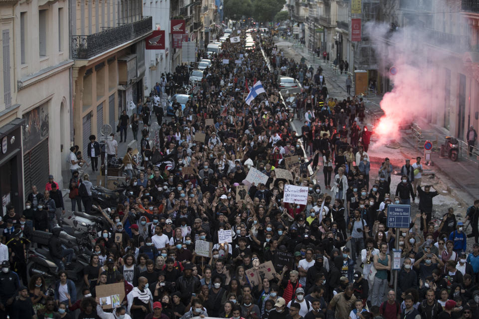 Protesters march against police brutality and racism in Marseille, France, Saturday, June 13, 2020, at a demonstration organized by supporters of Adama Traore, who died in police custody in 2016 in circumstances that remain unclear despite four years of back-and-forth autopsies. Several demonstrations went ahead Saturday inspired by the Black Lives Matter movement in the U.S. (AP Photo/Daniel Cole)