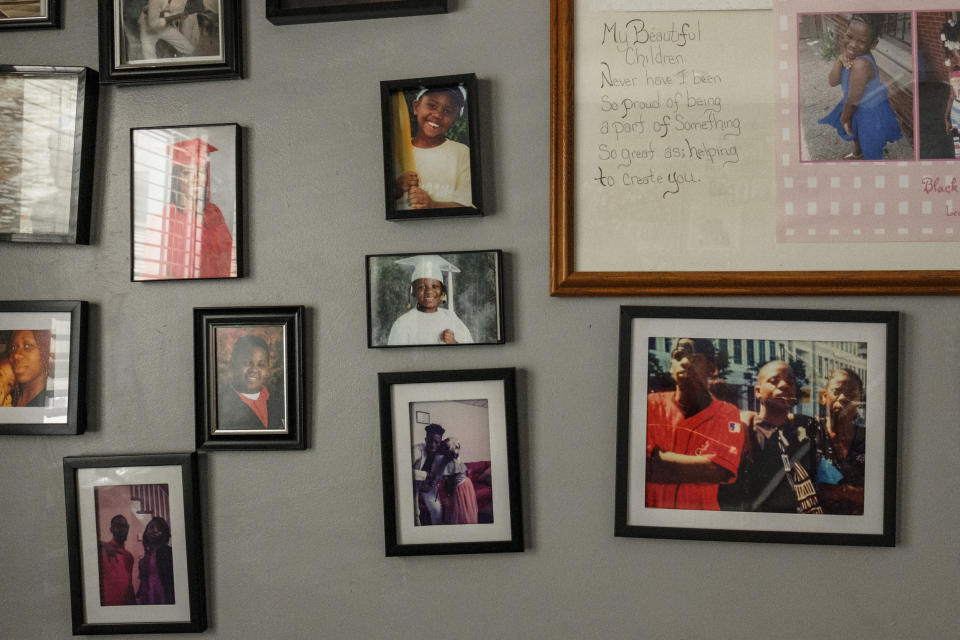 A wall of family photos in April Lee's home. (Stephanie Mei-Ling for NBC News and ProPublica)