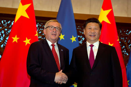 FILE PHOTO: European Commission President Jean-Claude Juncker, left and Chinese President Xi Jinping shake hands before a meeting held at the Diaoyutai State Guesthouse in Beijing, China, Tuesday, July 12, 2016. REUTERS/Ng Han Guan/Pool/File Photo