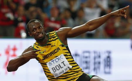 Usain Bolt of Jamaica celebrates after winning the men's 200 metres final during the 15th IAAF World Championships at the National Stadium in Beijing, China, August 27, 2015. REUTERS/David Gray