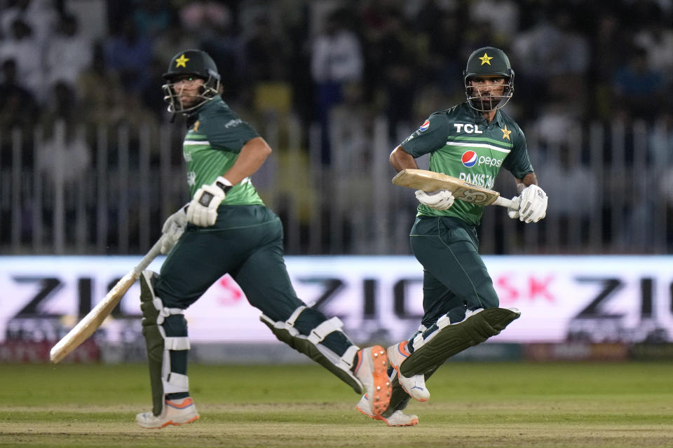 Pakistan's Fakhar Zaman, right, and Imam-ul-Haq take a run during the first one-day international cricket match between Pakistan and New Zealand, in Rawalpindi, Pakistan, Thursday, April 27, 2023. (AP Photo/Anjum Naveed)