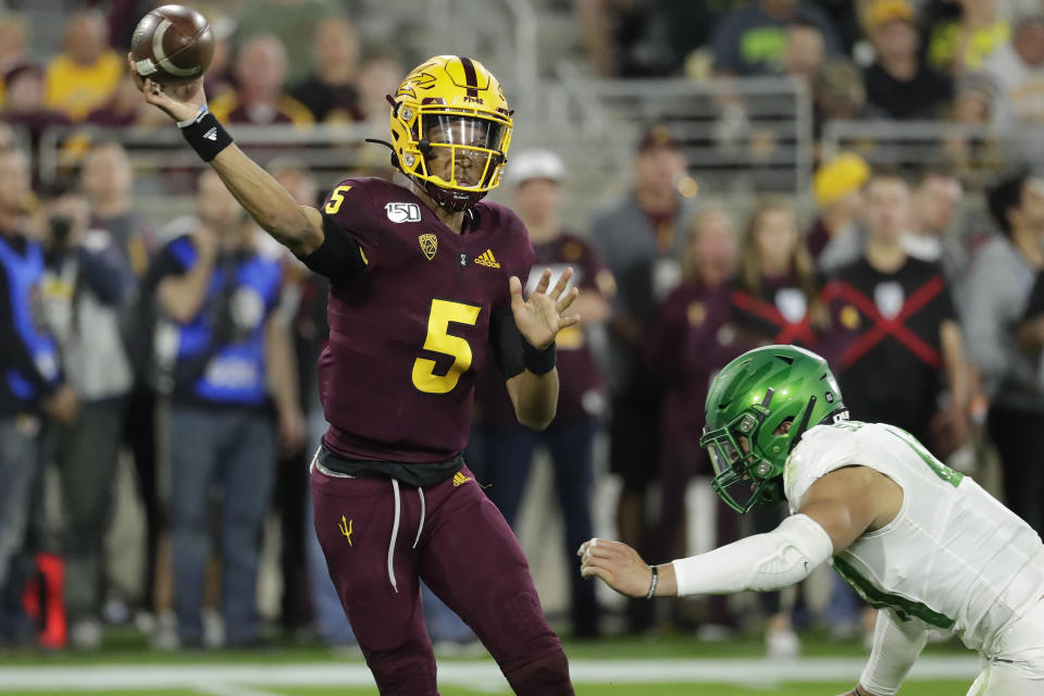 Arizona State quarterback Jayden Daniels (5) throws under pressure from Oregon linebacker Isaac Slade-Matautia on Nov. 23 in Tempe, Ariz. (AP Photo/Matt York)