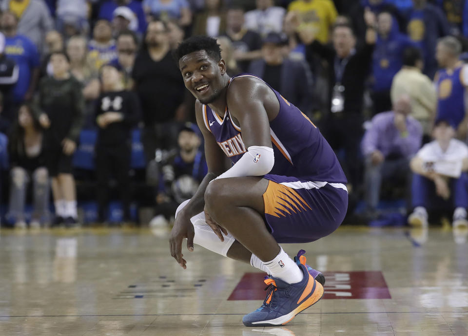 Phoenix Suns center Deandre Ayton smiles during the second half of his team's NBA basketball game against the Golden State Warriors in Oakland, Calif., Sunday, March 10, 2019. (AP Photo/Jeff Chiu)