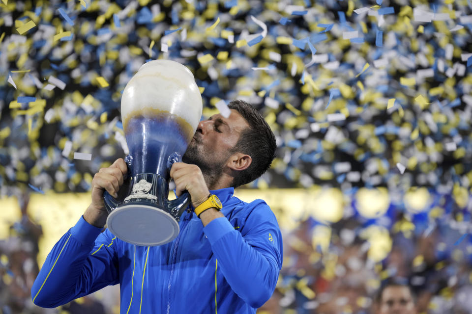 Novak Djokovic, of Serbia, kisses the Rookwood Cup as he poses for photos after defeating Carlos Alcaraz, of Spain, during the men's singles final of the Western & Southern Open tennis tournament, Sunday, Aug. 20, 2023, in Mason, Ohio. (AP Photo/Aaron Doster)