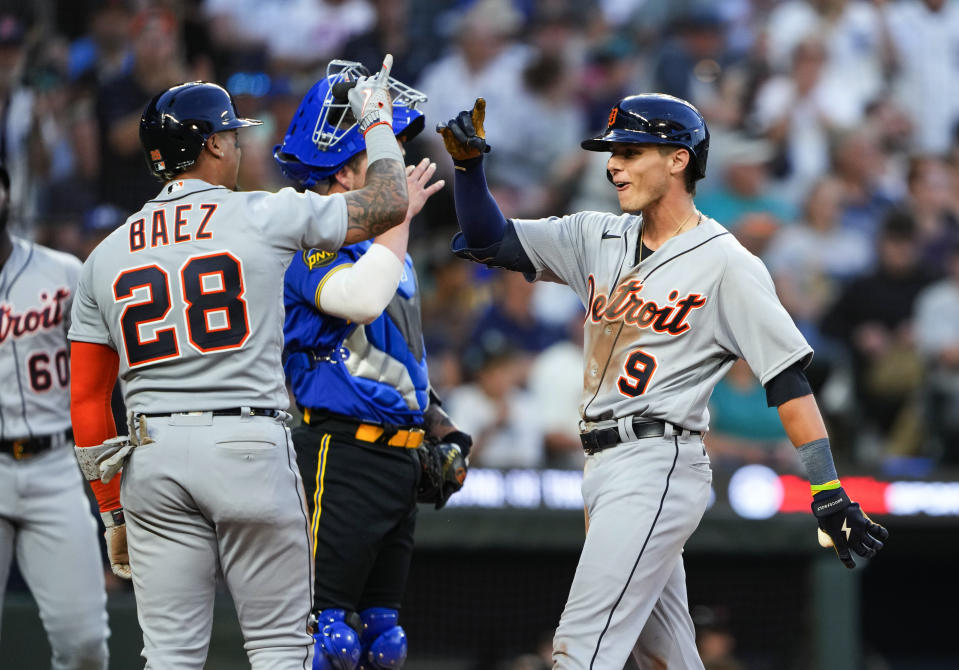 Detroit Tigers' Javier Baez (28) greets Nick Maton (9) after the scored on Maton's home run against the Seattle Mariners during the seventh inning of a baseball game Friday, July 14, 2023, in Seattle. (AP Photo/Lindsey Wasson)