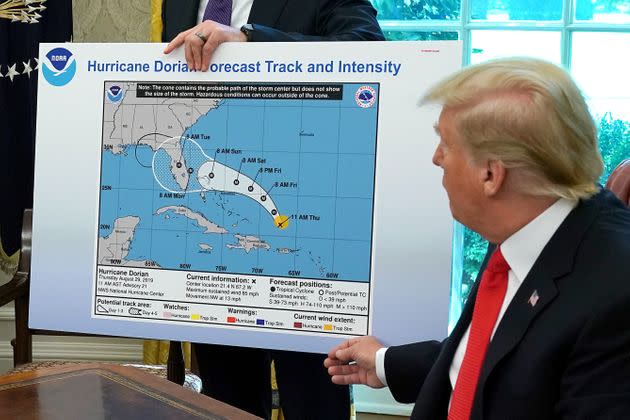 President Donald Trump references a map held by acting Homeland Security Secretary Kevin McAleenan, while talking to reporters following a briefing from officials about Hurricane Dorian in the Oval Office, on Sep. 4, 2019. The map appears to have been altered by a black marker to extend the hurricane's range to include Alabama. (Photo: Chip Somodevilla via Getty Images)