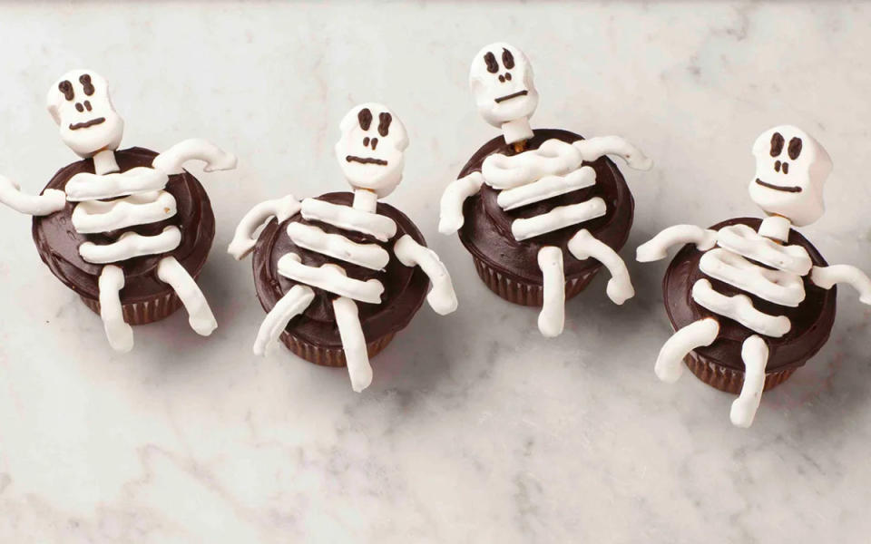 <p>Alan Richardson</p><p>Five ingredients are all you need to make these creepy-cute cupcakes that will get the attention of kids young and old when they approach the dessert table. </p><p><strong>Get the recipe: </strong><strong><a href="https://parade.com/1275704/parade/pretzel-skeleton-cupcakes/" rel="nofollow noopener" target="_blank" data-ylk="slk:Pretzel Skeleton Cupcakes;elm:context_link;itc:0;sec:content-canvas" class="link ">Pretzel Skeleton Cupcakes</a></strong></p>