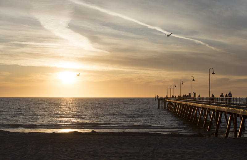 The sun sets over Glenelg Jetty in Adelaide.