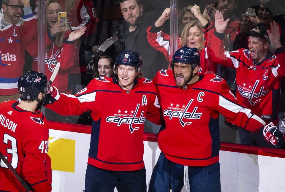 Washington Capitals left wing Alex Ovechkin (8), from Russia, celebrates after scoring as right wing Tom Wilson (43), from Canada, and Nicklas Backstrom (19), from Sweden, join during the first period of an NHL hockey game against the Carolina Hurricanes, Monday, Jan. 13, 2020, in Washington. (AP Photo/Al Drago)