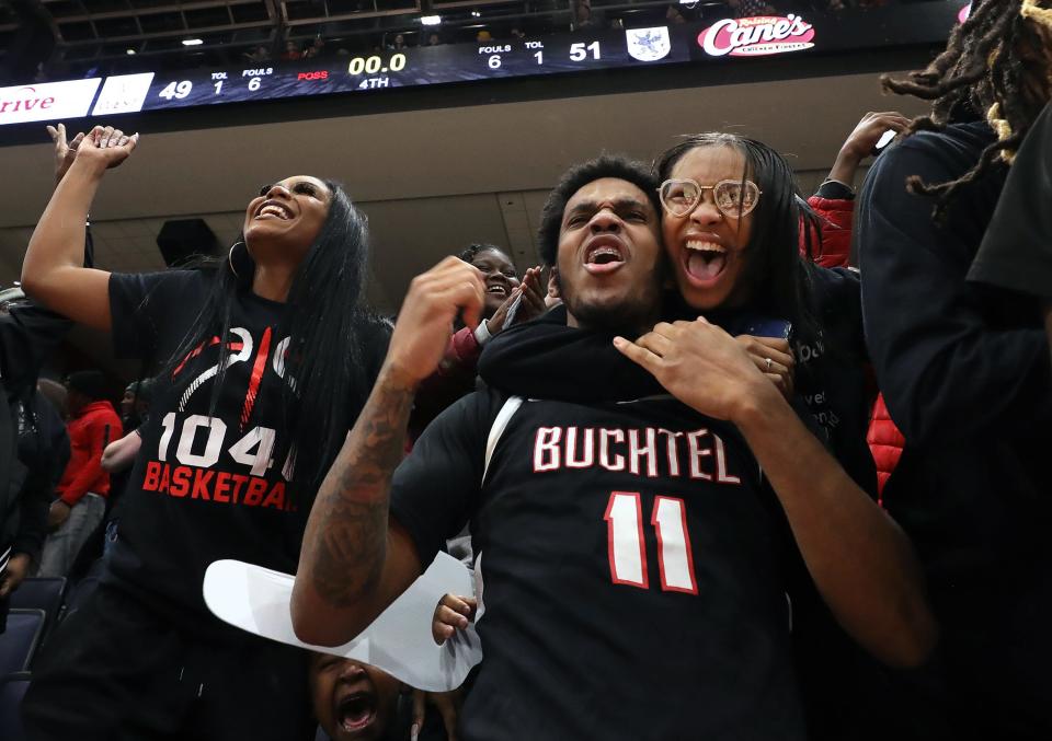 Buchtel guard Marcel Boyce Jr., center, celebrates with Griffins fans after winning the OHSAA Division II state championship, Sunday, March 19, 2023, in Dayton.