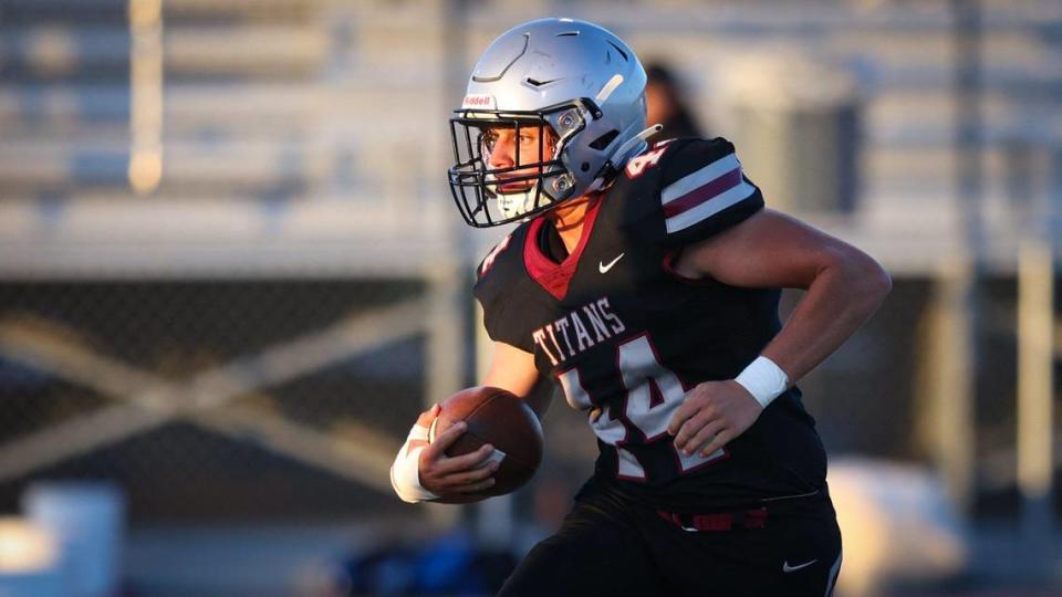 Ian Ackerman runs for the Titans. San Luis Obispo beat Nipomo 35-0 in the opening game of the season Aug. 19, 2022.