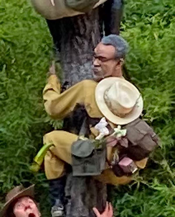 A man with bags of plants on his back