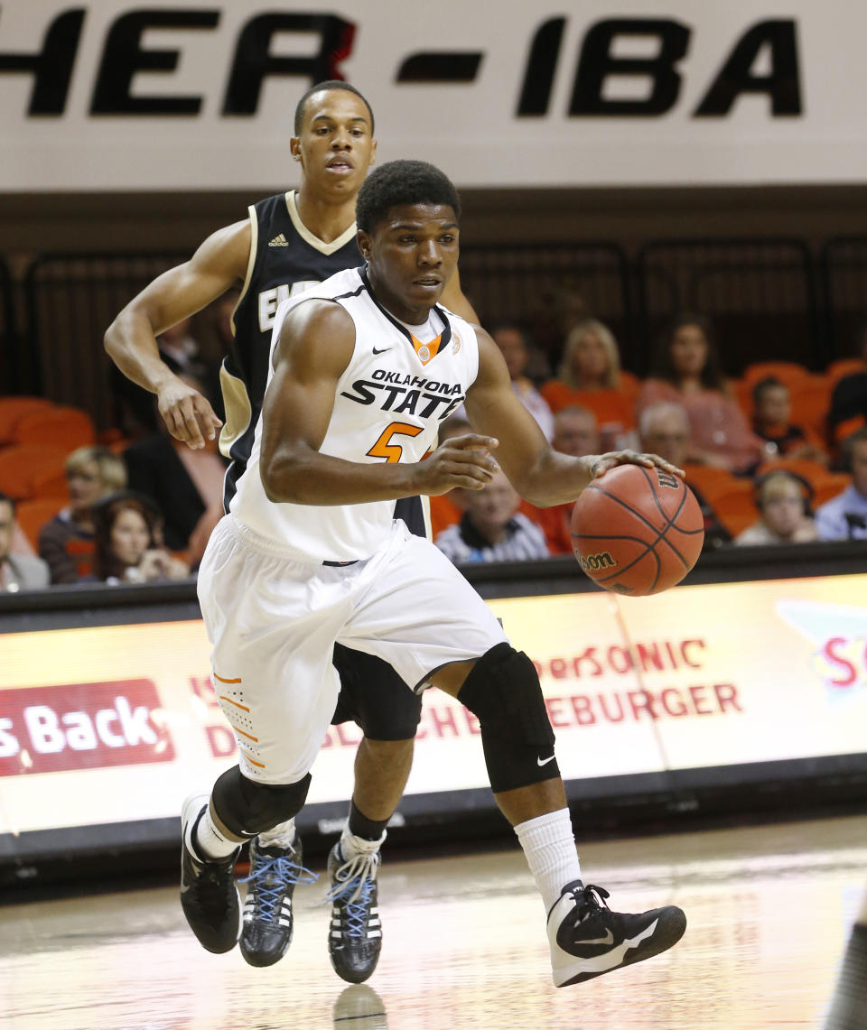 FILE - In this Nov. 1, 2013 file photo, Oklahoma State guard Stevie Clark (5) makes a drive in the second half of an NCAA college exhibition basketball game against Emporia State in Stillwater, Okla. Oklahoma State announced Monday, Feb. 3, 2014, that Clark has been kicked off the basketball team. (AP Photo/Sue Ogrocki, File)