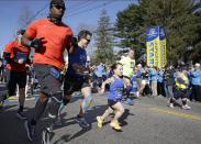 The 118th Boston Marathon gets underway as the mobility impaired runners leave the start line behind Monday, April 21, 2014 in Hopkinton, Mass. (AP Photo/Stephan Savoia)