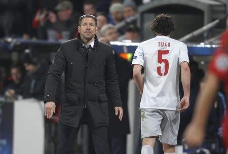 Atletico Madrid's Tiago Mendes walks past his coach Diego Simeone (L) after receiving a red card during the Champions League round of 16, first leg soccer match against Bayer Leverkusen, in Leverkusen February 25, 2015. REUTERS/Ina Fassbender