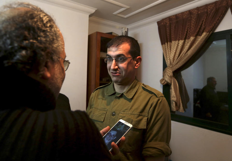 In this Sunday, Jan. 26, 2014 photo, director Majed Jundiyeh, left, talks to Mahmoud Karira who will play the character of Gilad Shalit in a movie being made in Gaza called, ''Losing Shalit," in Gaza City. "Losing Schalit," currently being filmed in the blockaded territory, is the first of a planned three-part series about the 2006 capture of Israeli soldier Gilad Schalit by gunmen allied with the Islamic militant Hamas movement. Parts two and three will depict Schalit's time in captivity and his 2011 swap for hundreds of Palestinian prisoners held by Israel. (AP Photo/Hatem Moussa)