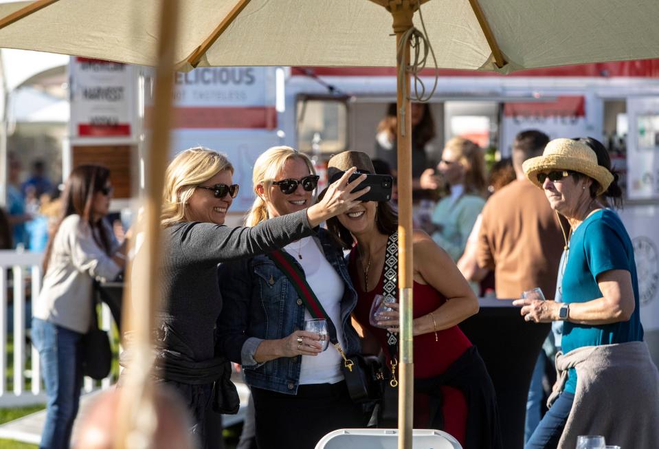 A group of friends take a selfie together at the Inaugural Palm Springs Wine & Food Experience at Palm Springs Stadium in Palm Springs, Calif., Saturday, Nov. 19, 2022. 