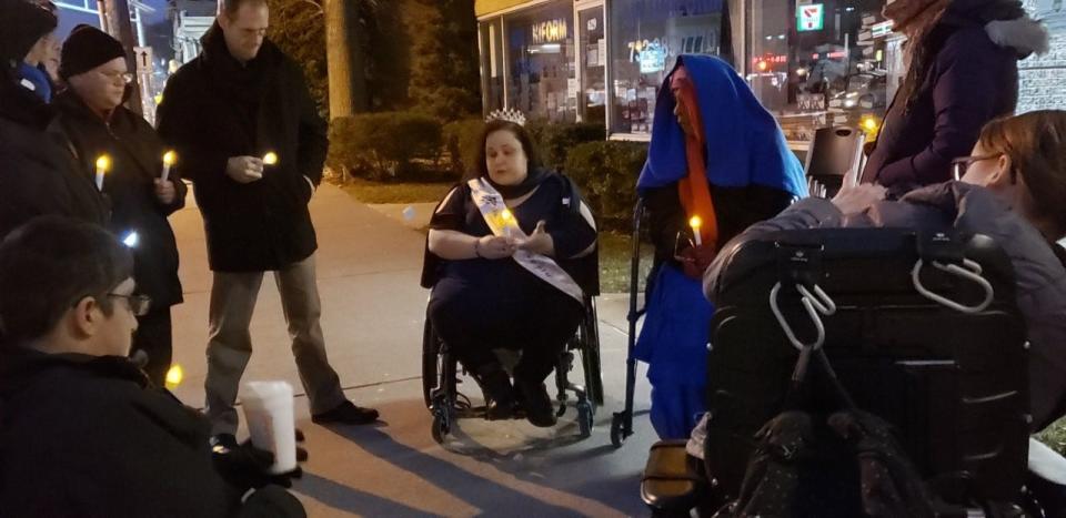 Millie Gonzalez (center, in wheelchair) attends an annual vigil to highlight violence against people with disabilities, who have been murdered by family members and caretakers.