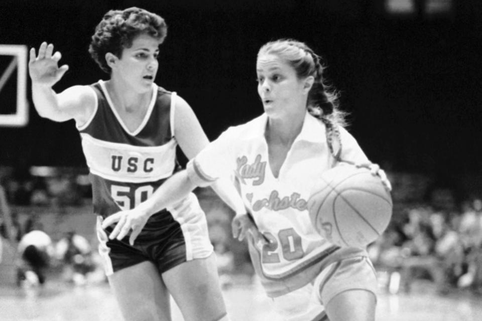 FILE - Louisiana Tech's Kim Mulkey, right, moves around USC's Amy Alkek during an NCAA women's college basketball tournament at Los Angeles, March 31, 1984. (AP Photo/Doug Pizac, File)