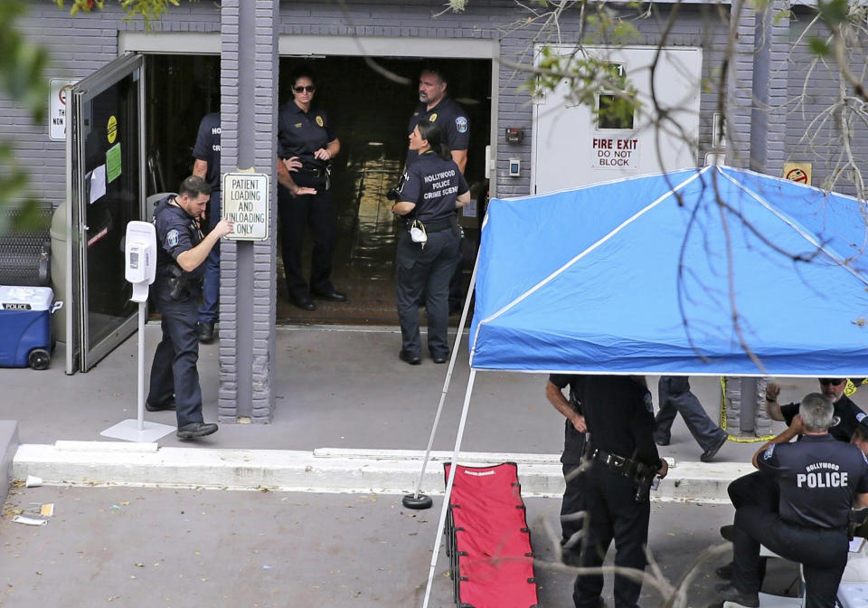 FILE - A Sept. 13, 2017 file photo shows a police staging area at the south entrance of the Rehabilitation Center at Hollywood Hills where residents died, in Hollywood, Fla. Defense attorneys said Sunday, August 25, 2019 that arrests are expected shortly in the case of the Florida nursing home where 12 elderly patients died after the complex lost power and was engulfed by sweltering heat during the powerful 2017 Hurricane Irma.(Charles Trainor Jr./Miami Herald via AP, File)