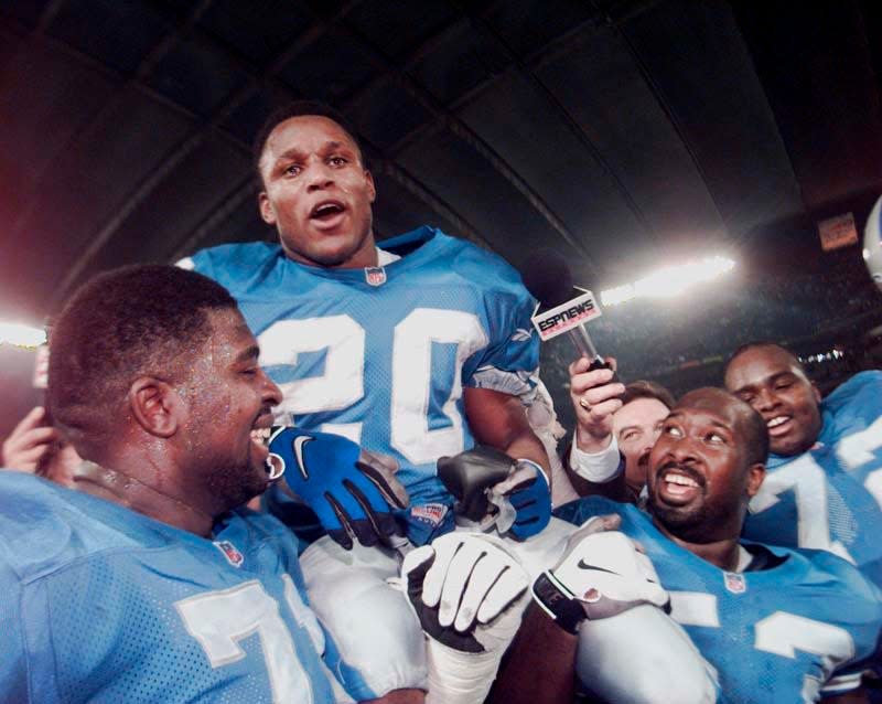 Detroit Lions running back Barry Sanders gets a ride on the shoulders of offensive linemen Kevin Glover, right, and Ray Roberts, left, on Sunday, Dec. 21, 1997 at the Pontiac Silverdome. Sanders celebrates a 2,053-yard season.