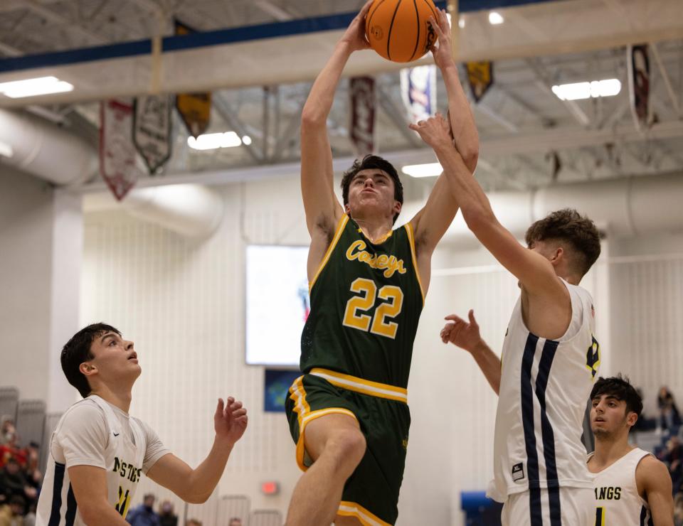 Red Bank Catholic's Gioacchino Panzini (No. 22 with the ball) elevates toward the rim as Marlboro's Jack Seidler (No. 22) tries to stop him with teammate Jay Ratner (No. 20) looks on. Marlboro Boys Basketball vs Red Bank Catholic in WOBM Christmas Classic Final on December 30, 2021 in Toms River, NJ.