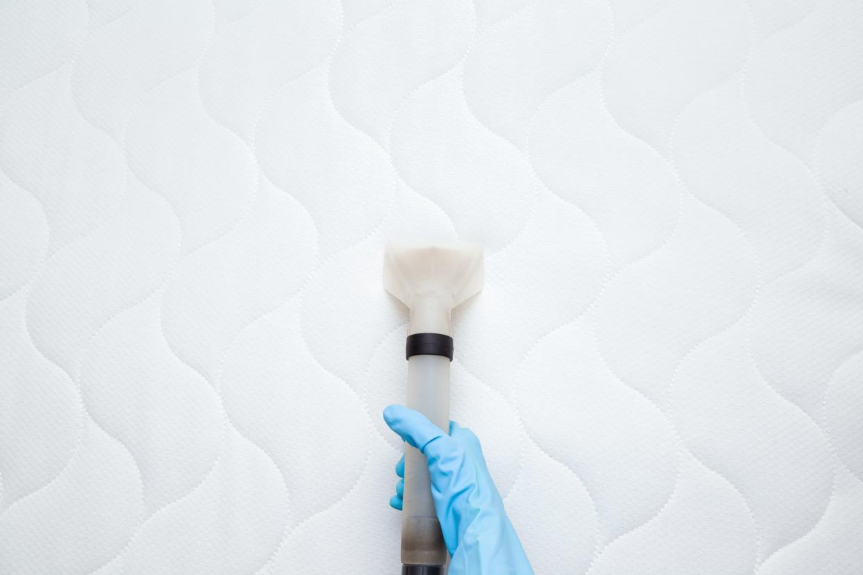 overhead shot of person vacuuming mattress