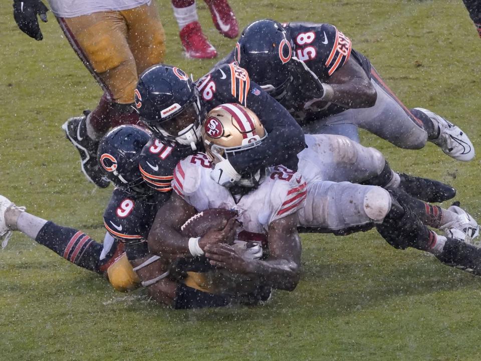 Jeff Wilson Jr. is tackled by the Chicago Bears defense.