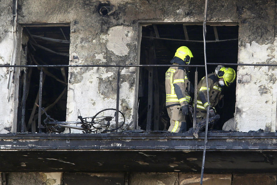 Firefighters remove a charred body inside a burned block building in Valencia, Spain, Friday, Feb. 23, 2024. Firefighters and scientific police began inspecting the interior of two residential towers that were destroyed by fire in the eastern Spanish city of Valencia. / Credit: Alberto Saiz / AP