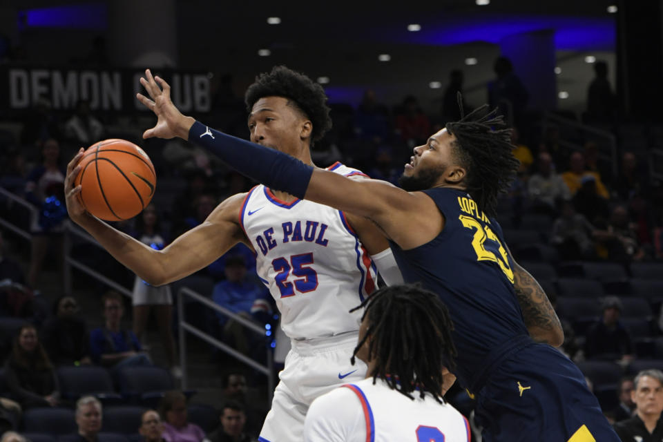 Marquette's David Joplin (23) battles DePaul's Jeremiah Oden (25) for a rebound during the first half of an NCAA college basketball game Wednesday, Jan. 24, 2024, in Chicago. (AP Photo/Paul Beaty)