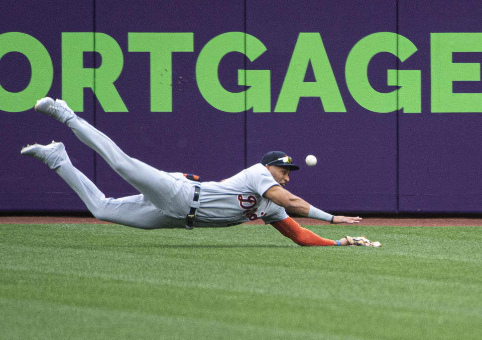 Detroit Tigers center fielder Victor Reyes can't catch a fly ball hit by Cleveland Indians' Cesar Hernandez during the first inning of a baseball game in Cleveland, Saturday, April 10, 2021. (AP Photo/Phil Long)