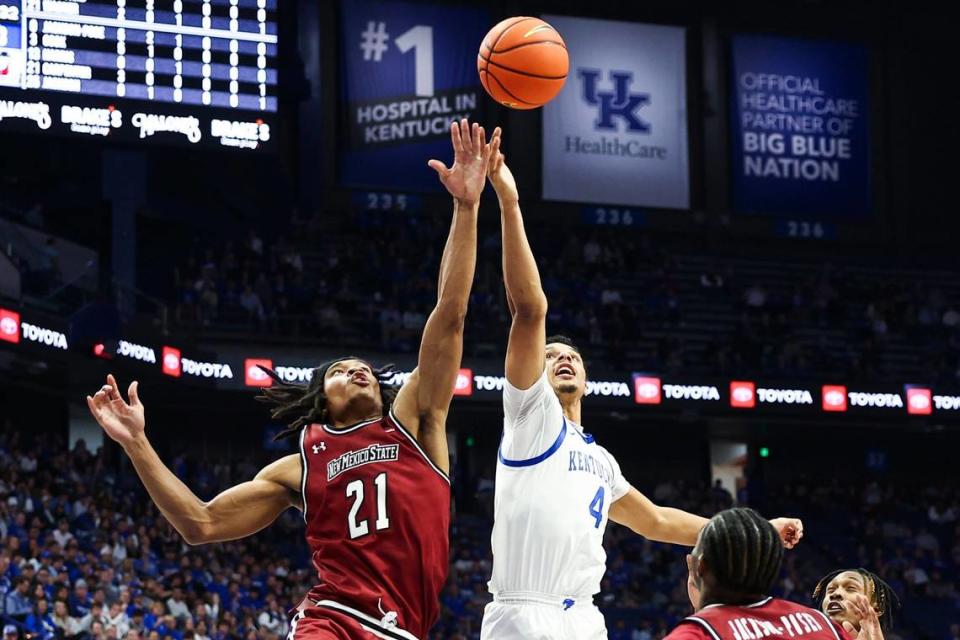 Kentucky’s Tre Mitchell (4) reaches for a rebound against New Mexico State’s Robert Carpenter (21) on Monday night. The transfer from West Virginia led UK with nine rebounds in his Wildcats debut. Silas Walker/swalker@herald-leader.com