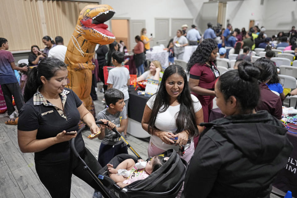 Residents gather for National Night Out inside the community center in the Colony Ridge development Tuesday, Oct. 3, 2023, in Cleveland, Texas. The booming Texas neighborhood is fighting back after Republican leaders took up unsubstantiated claims that it has become a magnet for immigrants living in the U.S. illegally and that cartels control pockets of the neighborhood. (AP Photo/David J. Phillip)