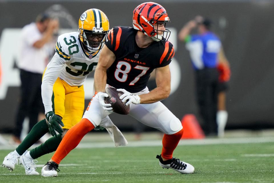 Cincinnati Bengals tight end <a class="link " href="https://sports.yahoo.com/nfl/players/31257" data-i13n="sec:content-canvas;subsec:anchor_text;elm:context_link" data-ylk="slk:Tanner Hudson;sec:content-canvas;subsec:anchor_text;elm:context_link;itc:0">Tanner Hudson</a> (87) completes a catch as Green Bay Packers safety Tarvarius Moore (30) defends in the second quarter during a Week 1 NFL preseason game between the Green Bay Packers and the Cincinnati Bengals,Friday, Aug. 11, 2023, at Paycor Stadium in Cincinnati.